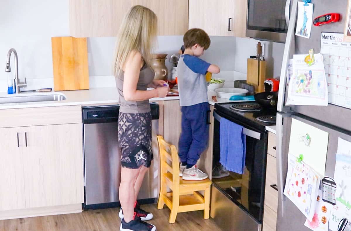 John is sprinkling breadcrumbs into a pie dish next to the stove