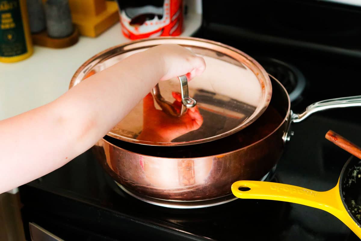 Katalina is placing the saucier top on the pan
