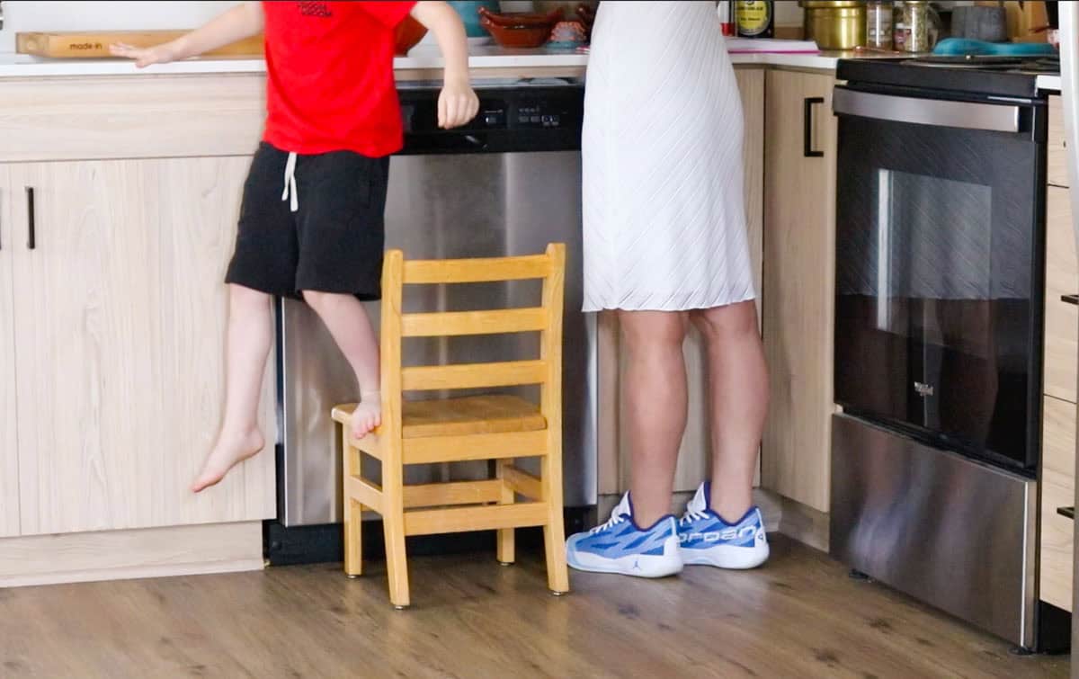 John is hopping down from his chair at the counter