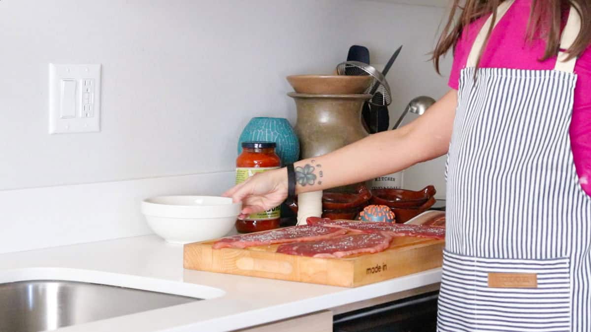 Kristin is grabbing some provologne cheese to place on top of the steak