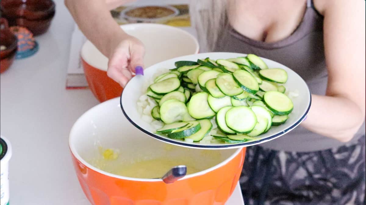 Kristin is showing ingredients for making zucchini casserole to the camera