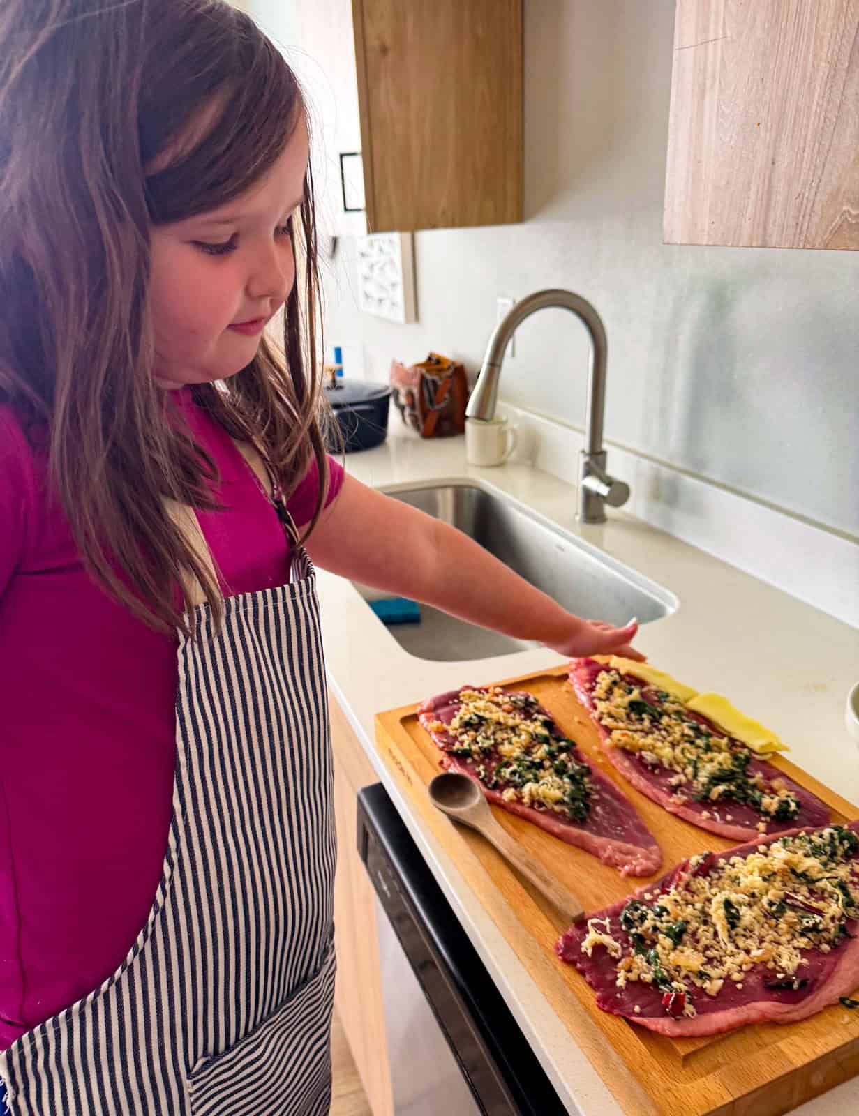 Kat beside breadcrumb and swiss chard mixture over steak