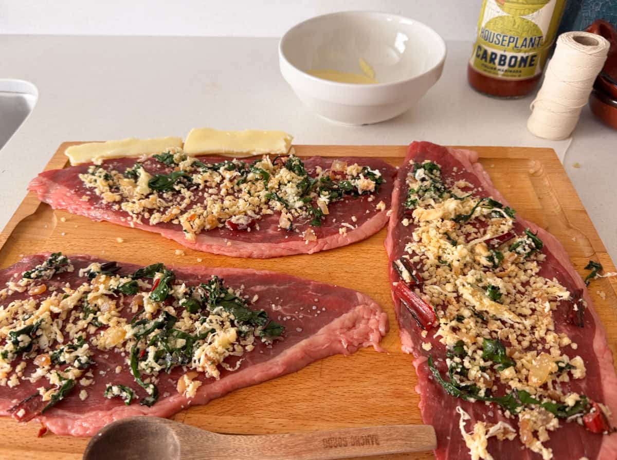 breadcrumb and swiss chard mixture over steak