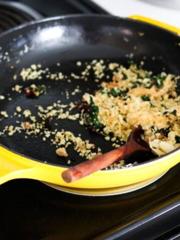 breadcrumb mixture in an enameled cast-iron skillet