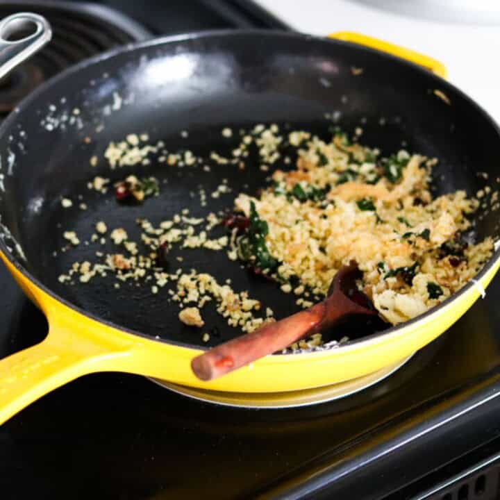 breadcrumb mixture in an enameled cast-iron skillet