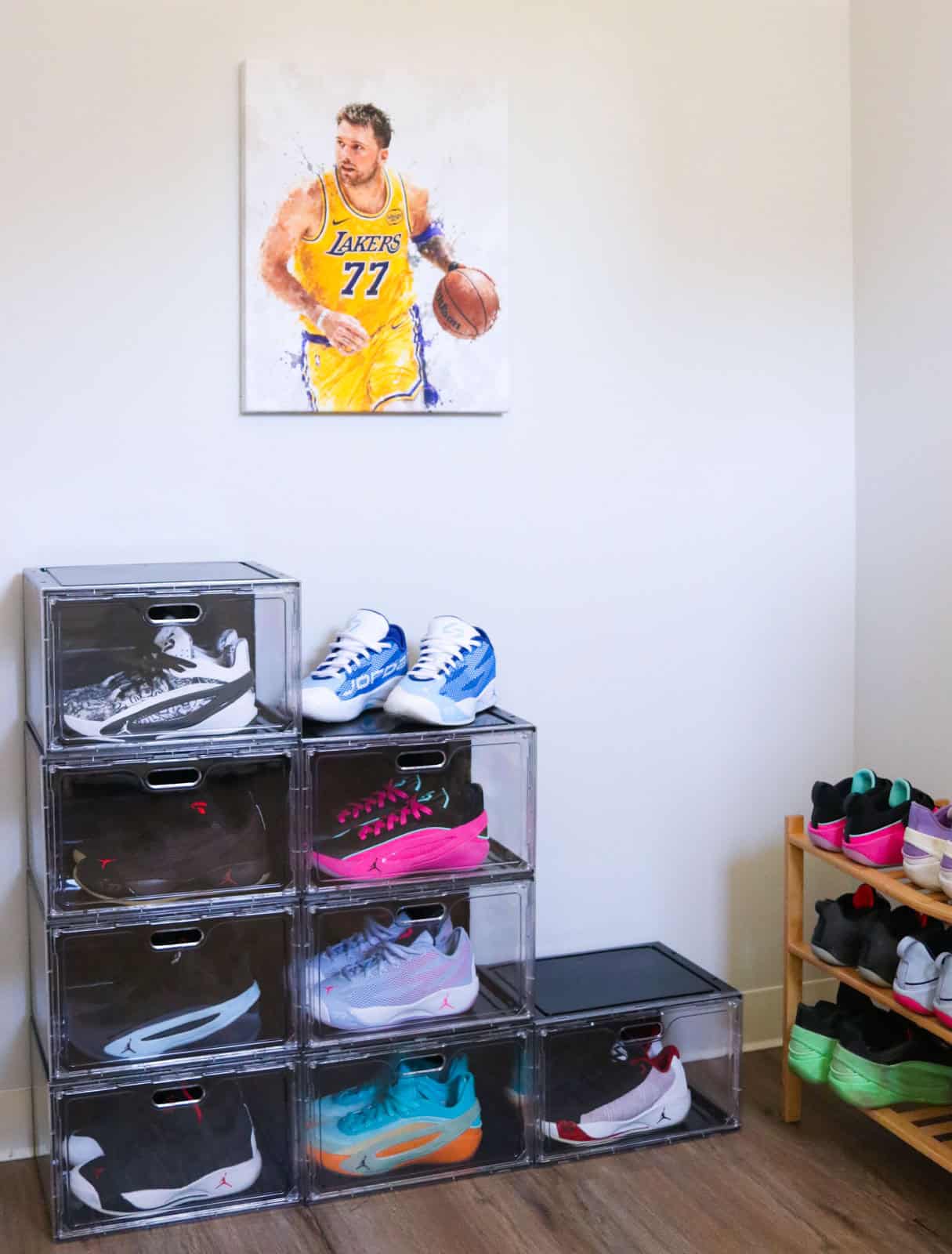entryway with shoe display boxes and a shoe rack containing Jordan Luka basketball shoes. Hanging above is a canvas with Luka in a Lakers jersey dribbling a basketball.