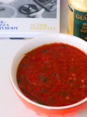 ny pizza sauce beside The Scarr's Pizza Cookbook and Giadzy extra virgin olive oil