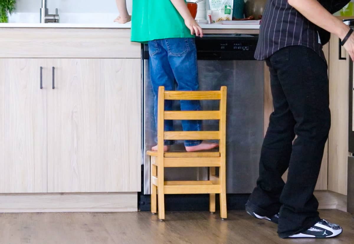 Kristin is grabbing items for John to strain basil