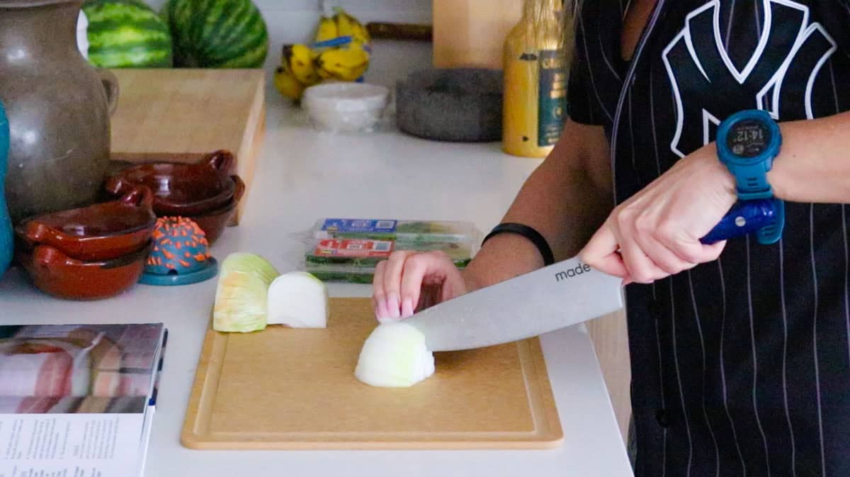 Kristin is slicing onion for pizza sauce