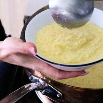 stracciatella is being ladled into a bowl