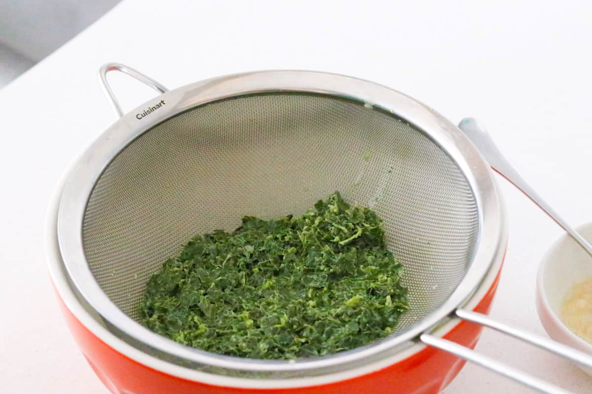 strained basil over a bowl