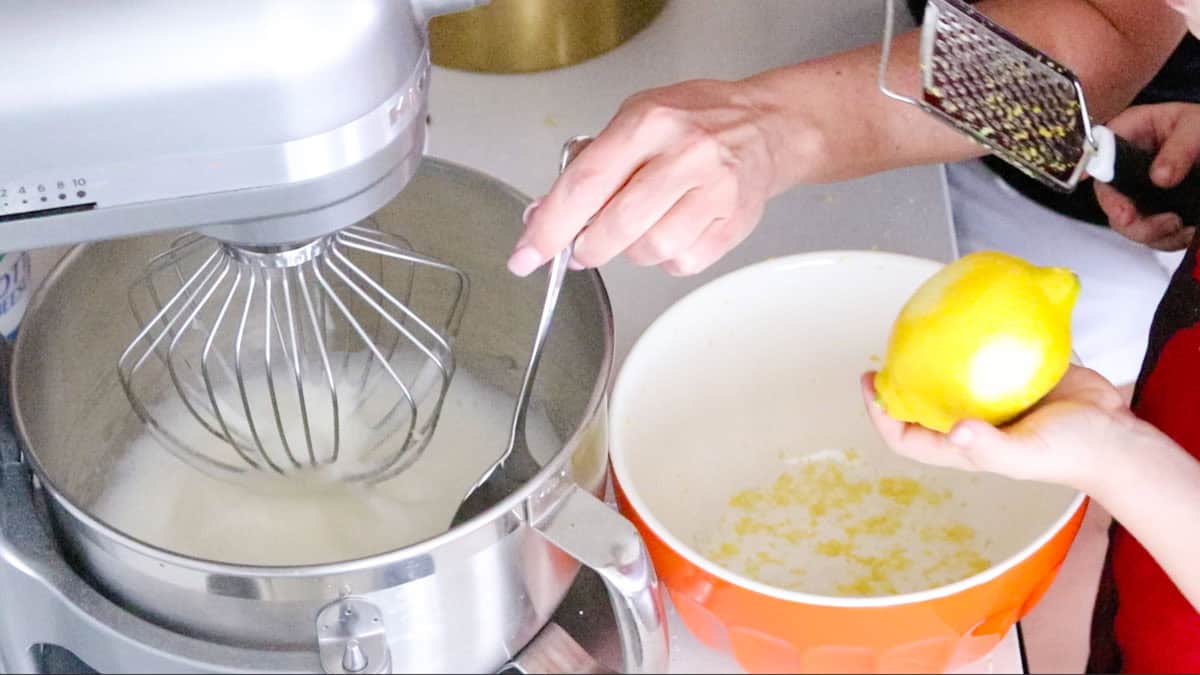 Kristin is checking the egg whites and John is zesting a lemon