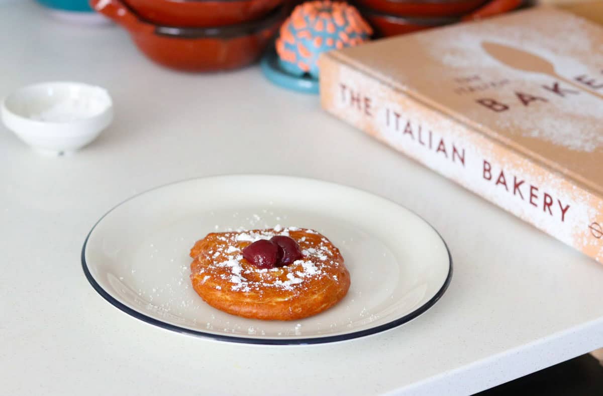 plated zeppole beside The Italian Bakery