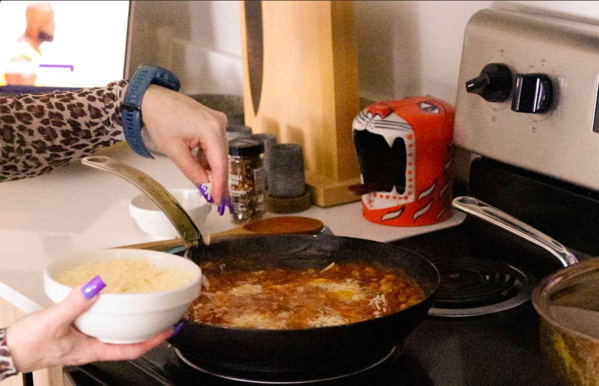 sprinkling parmesan over the pan