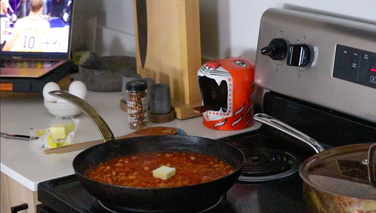 butter on top of eggs in pugatory ingredients cooking in a pan