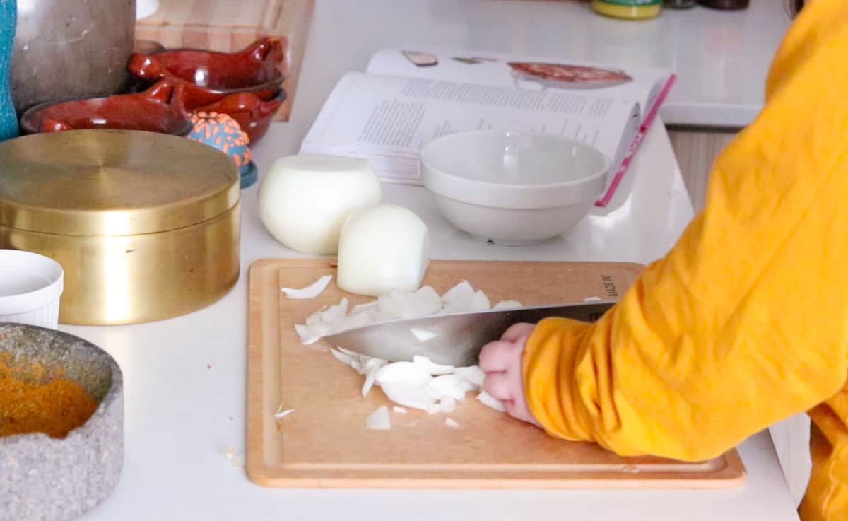 Kat is slicing onion with a chef knife