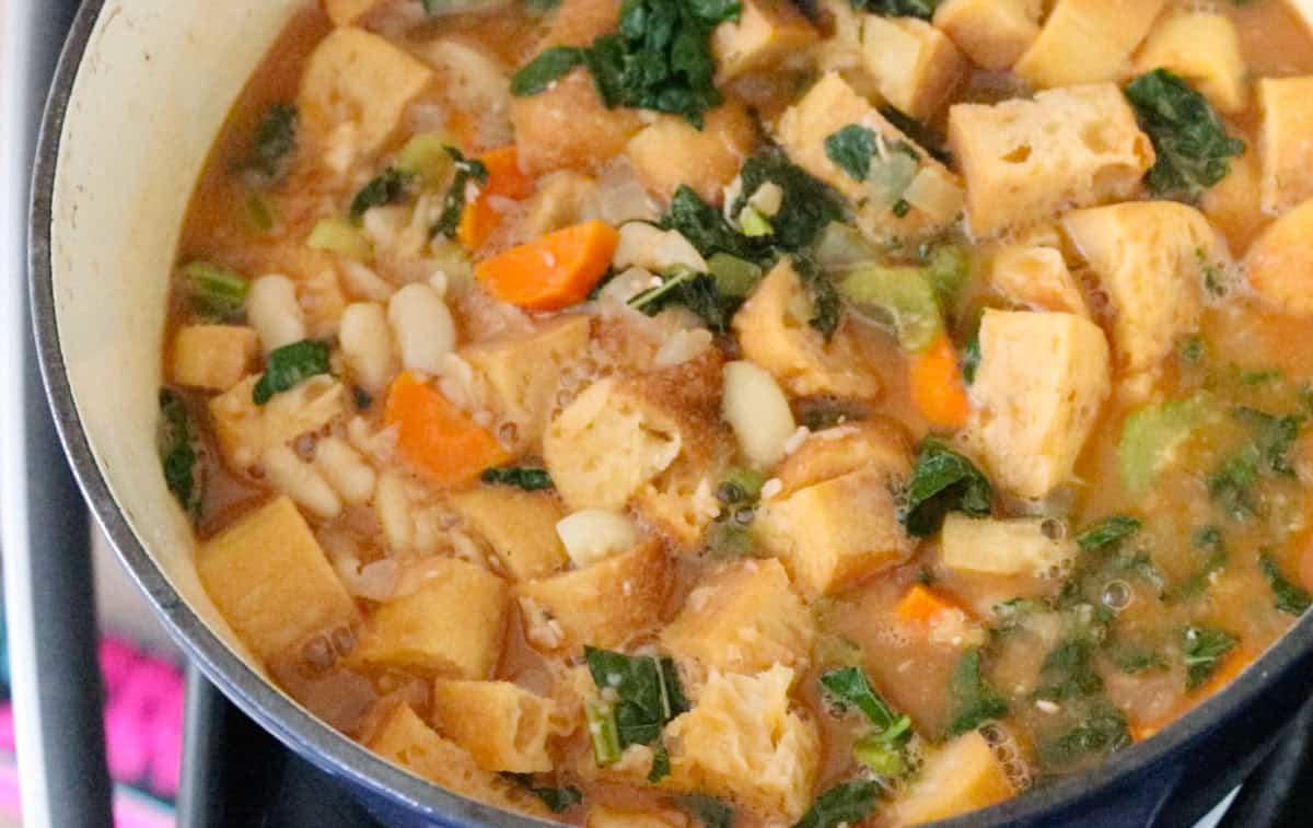 bread cubes and other ribollita ingredients in a Dutch oven