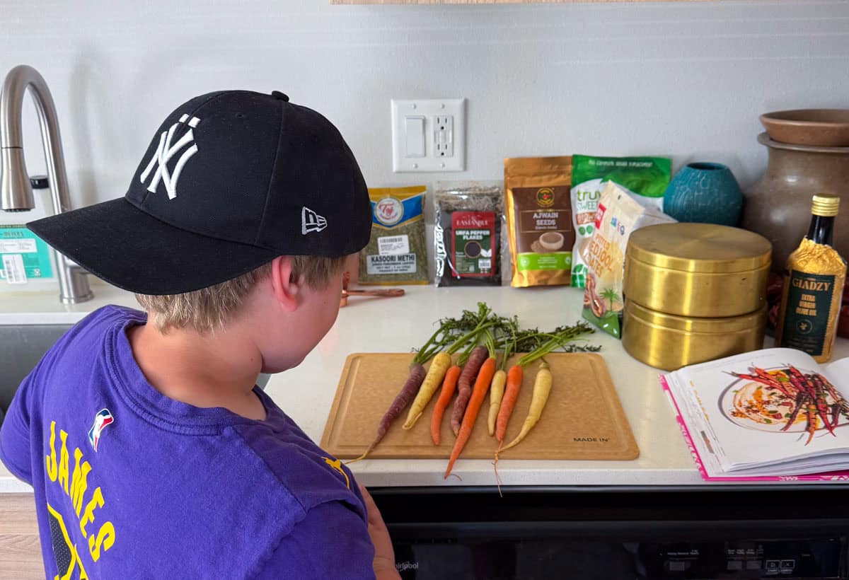 Noah is looking at the colorful carrots