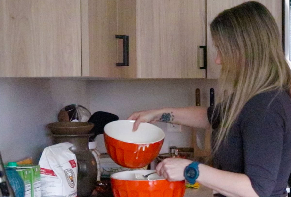 Kristin is combining wet and dry ingredients for corn dumplings