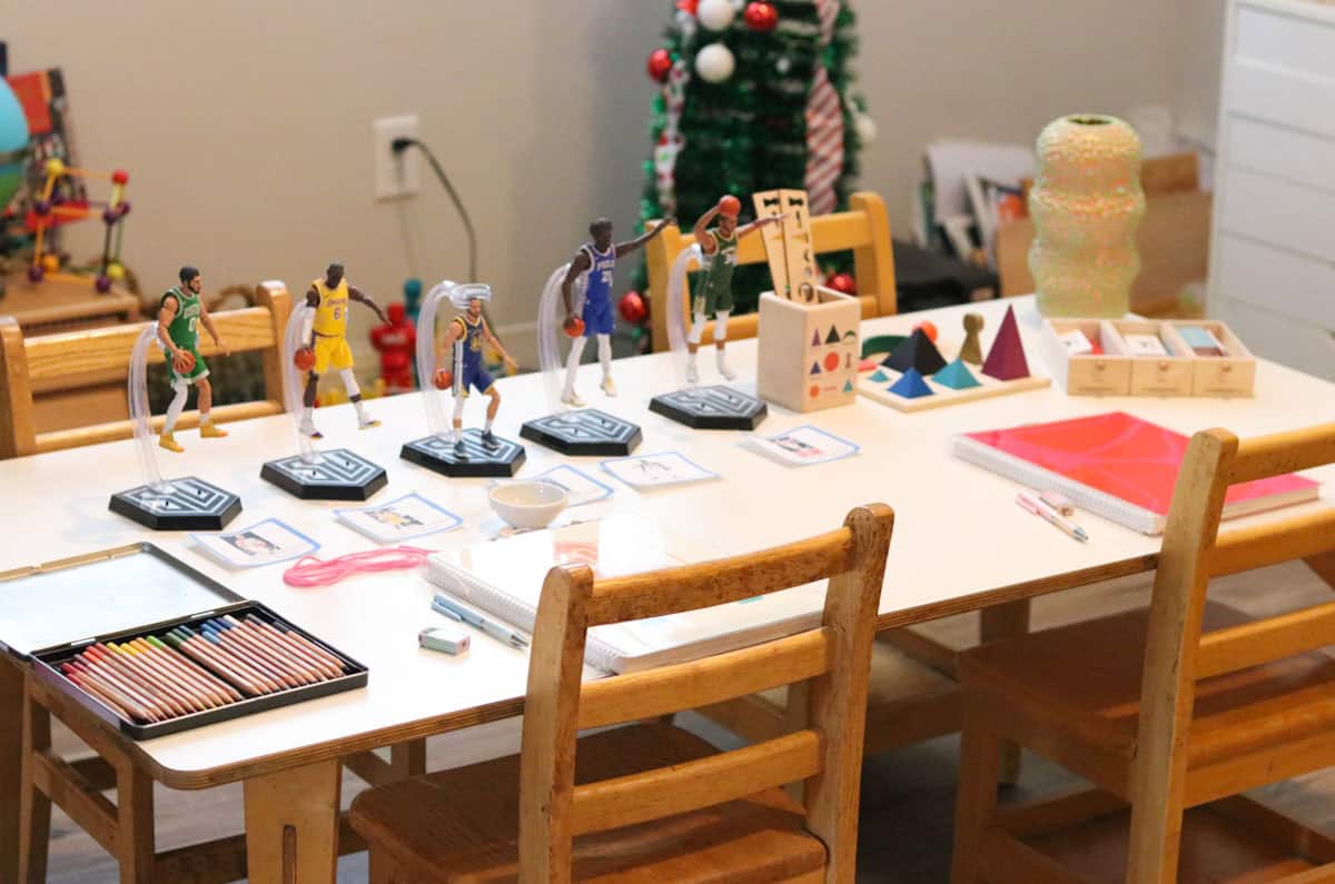 nba action figures, colored pencils, and Montessori grammar symbols on a table