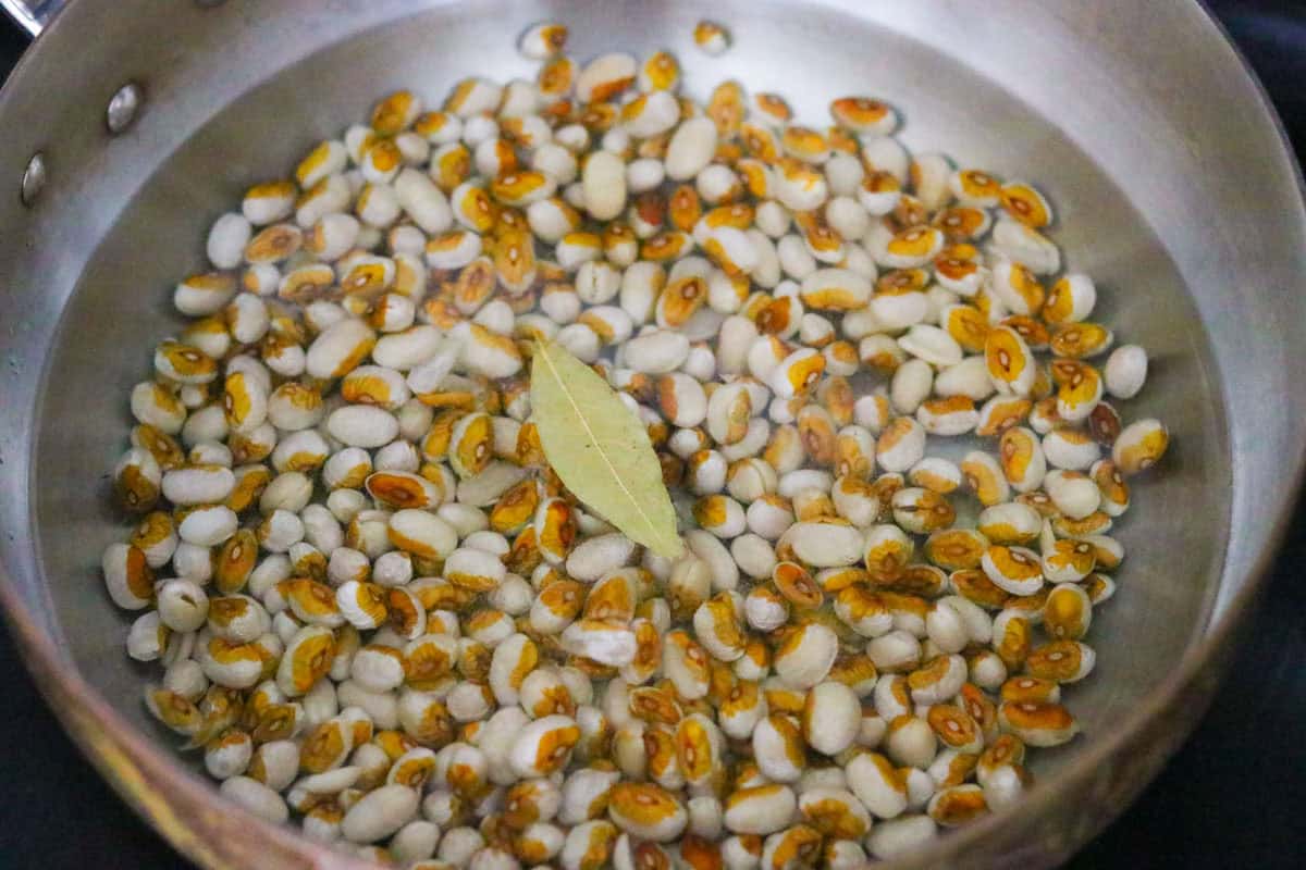 yellow eye beans and bay leaf in a saucier