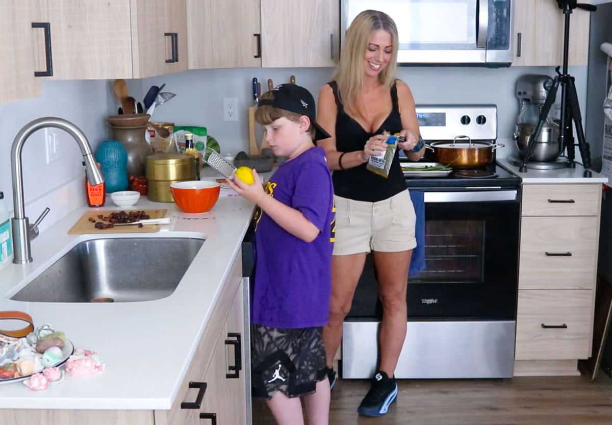 Kristin is opening all the spices and Noah is zesting a lemon