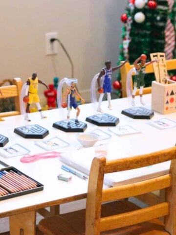 nba action figures, colored pencils, and Montessori grammar symbols on a table