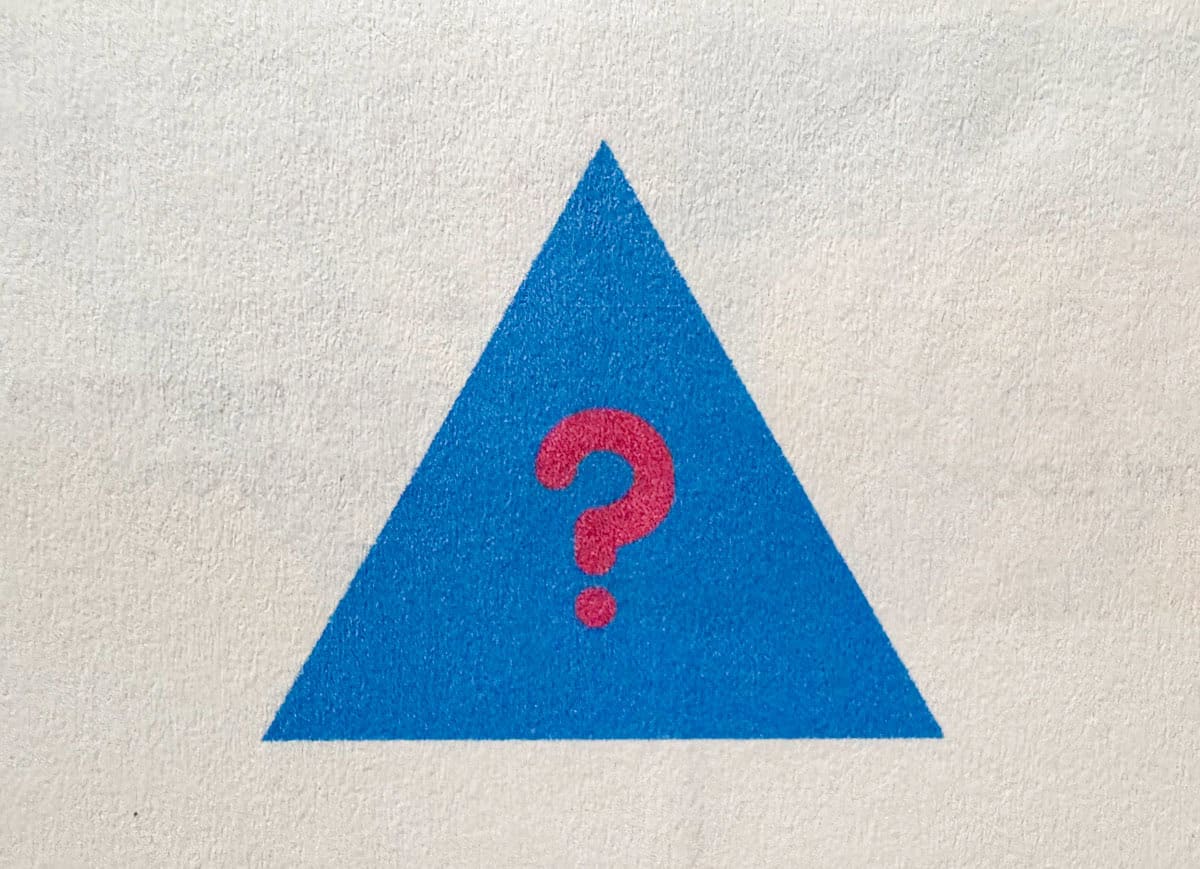 triangle with a question mark inside, symbol for an interrogative adjective
