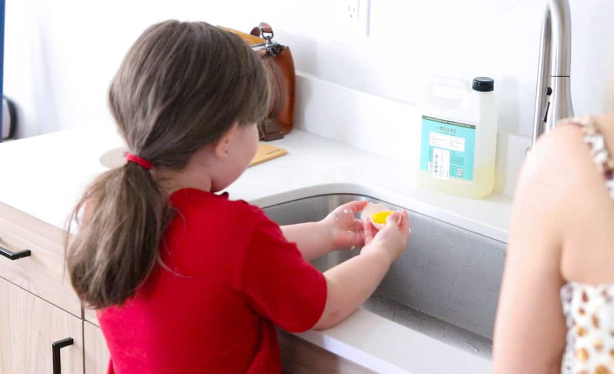 Kat is separating eggs at the sink