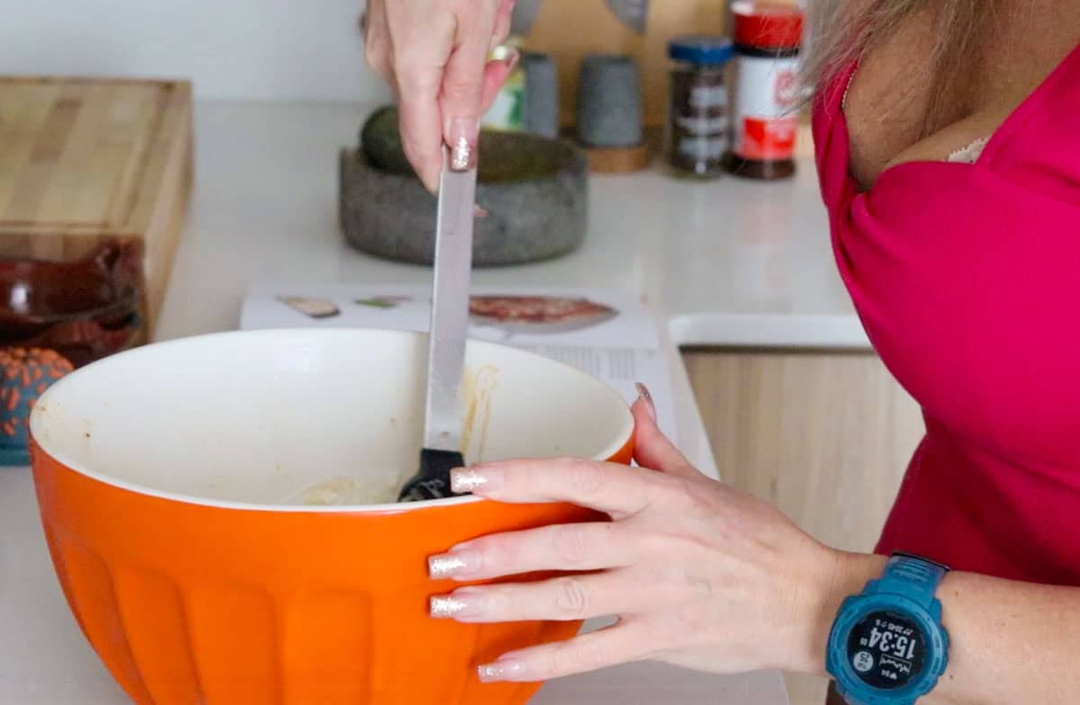 Kristin is stirring the tikka paste