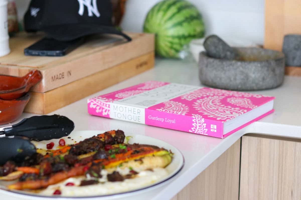urfa chilli carrots and salted chai yogurt with dates beside Mother Tongue cookbook