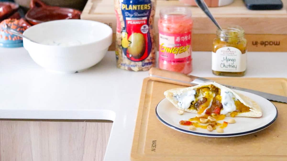 peanut butter-tandoori mushroom pitta plated and beside peanuts, ginger, and mango chutney