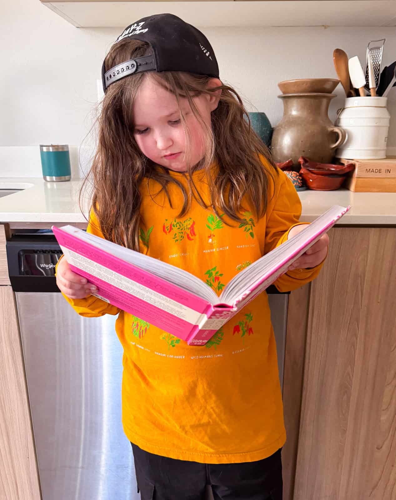 Kat is looking at the chicken tikka masala recipe and photo in Mother Tongue