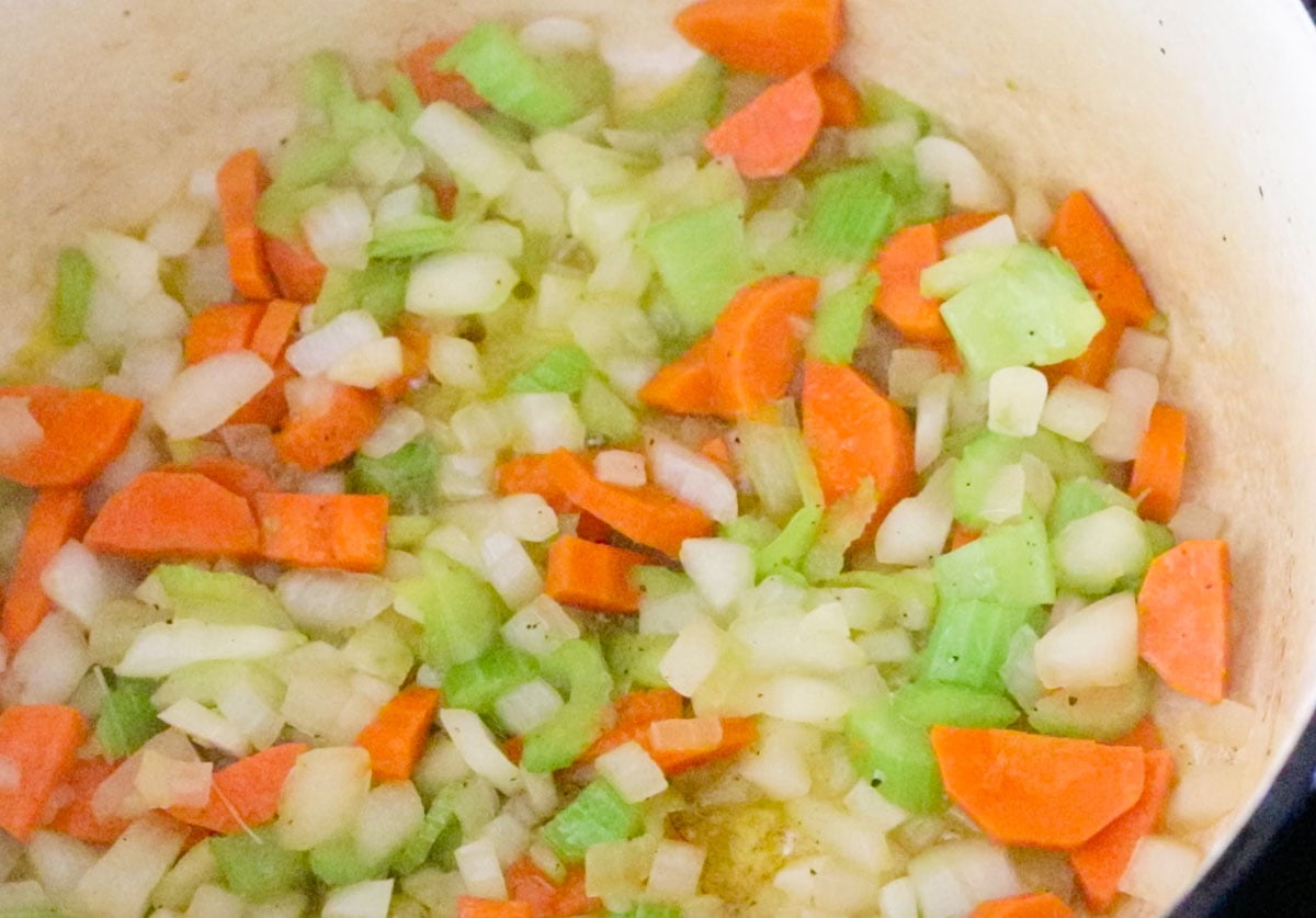onion, celery, carrots, salt and pepper cooking in oil