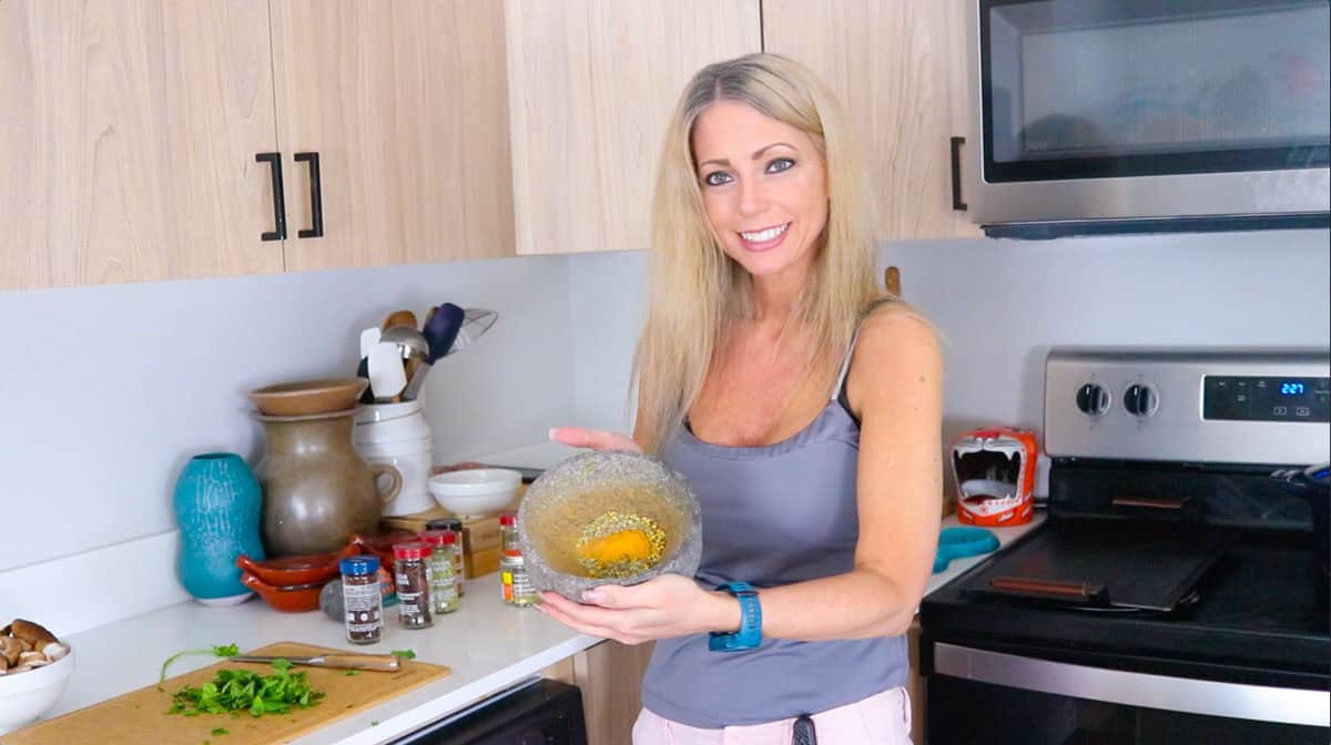 Kristin is holding a molcajete with spices in it