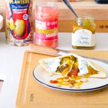 peanut butter-tandoori mushroom pitta plated and beside peanuts, ginger, and mango chutney