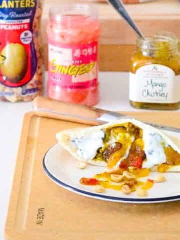 peanut butter-tandoori mushroom pitta plated and beside peanuts, ginger, and mango chutney