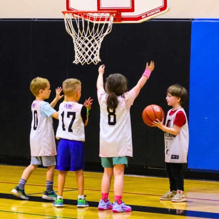Kat and John playing in a Jr. NBA/YMCA youth basketball game