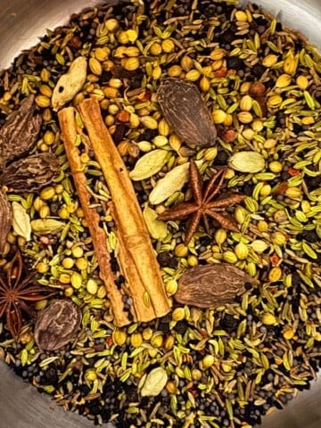 black masala spices in a saucepan