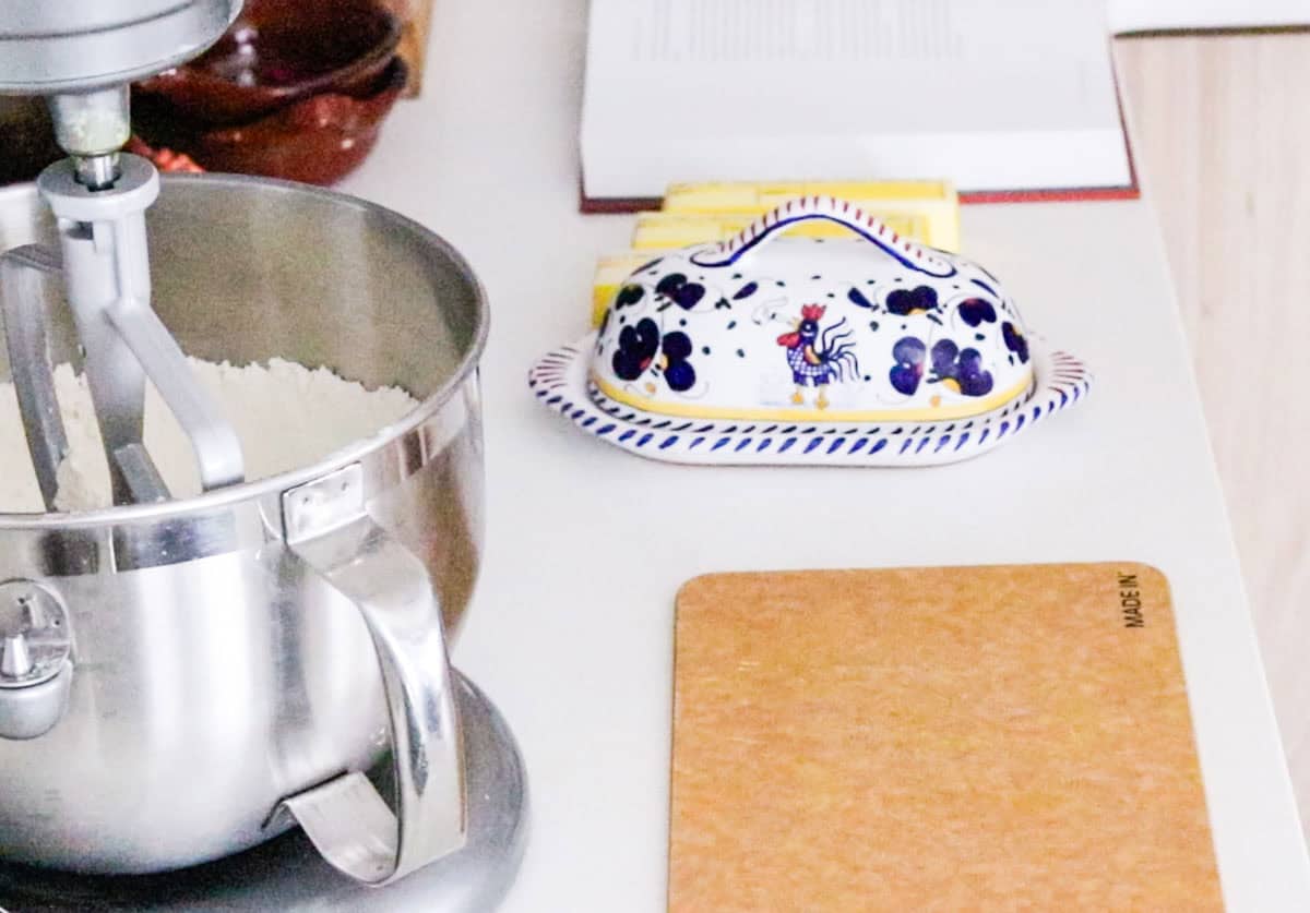 a butter dish, 3 additional sticks of butter, a cutting board, and a stand mixer