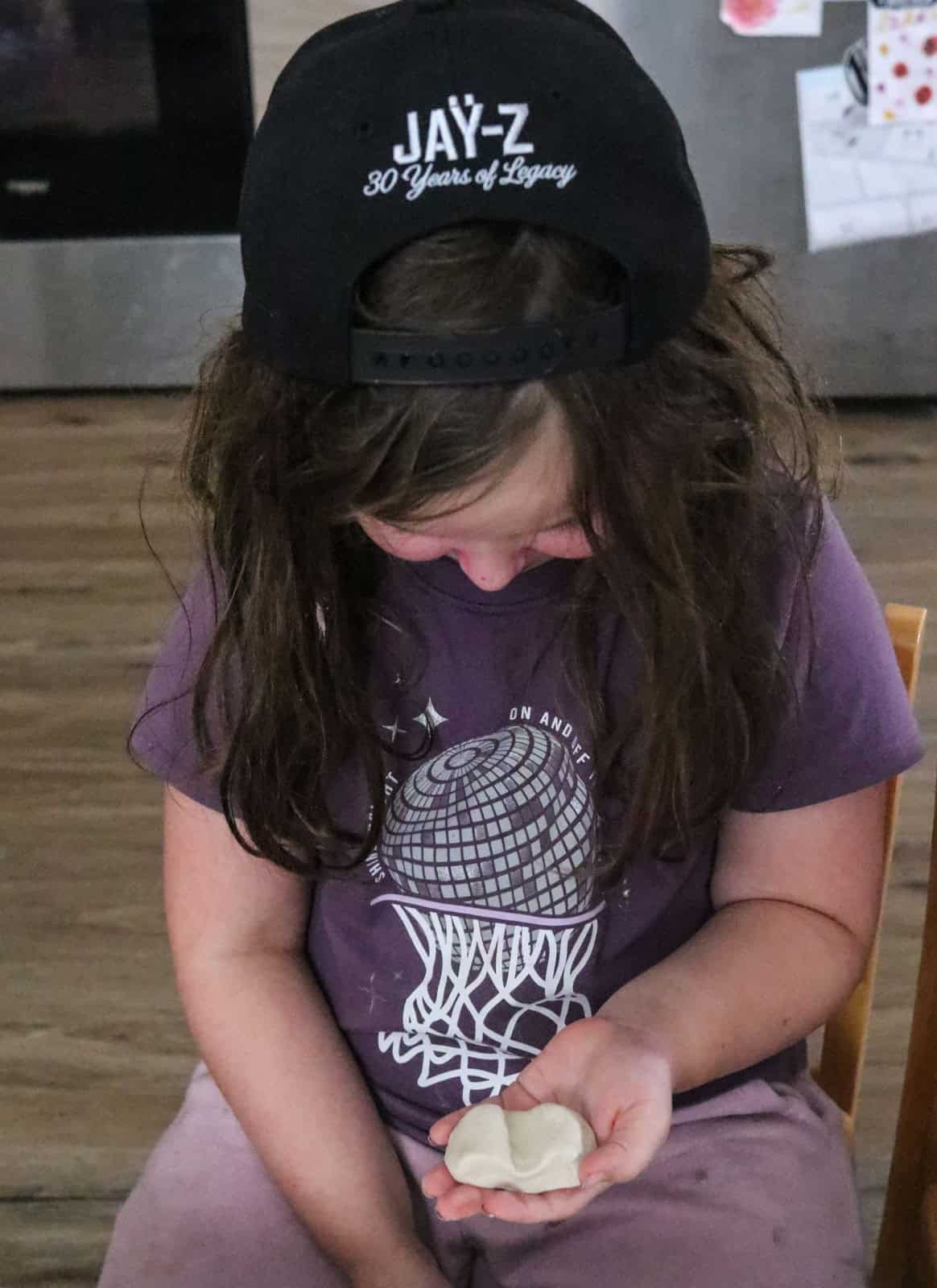 Kat is holding a clay model sports car she is working on