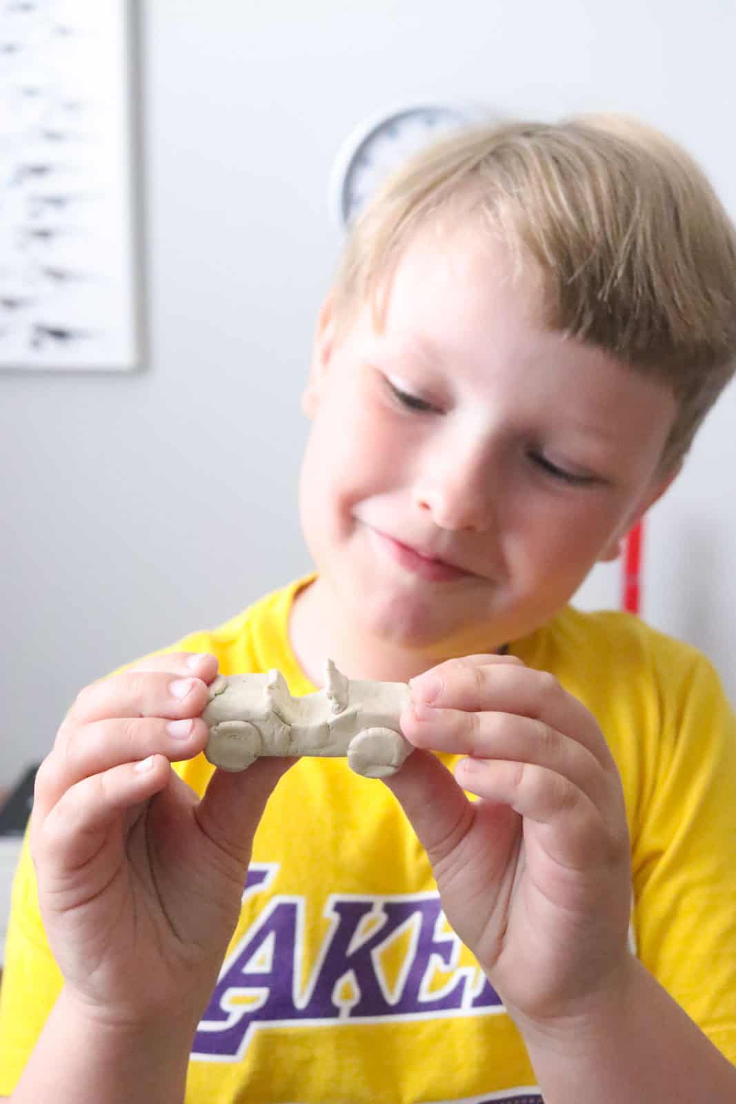 Noah is holding his clay model sports car