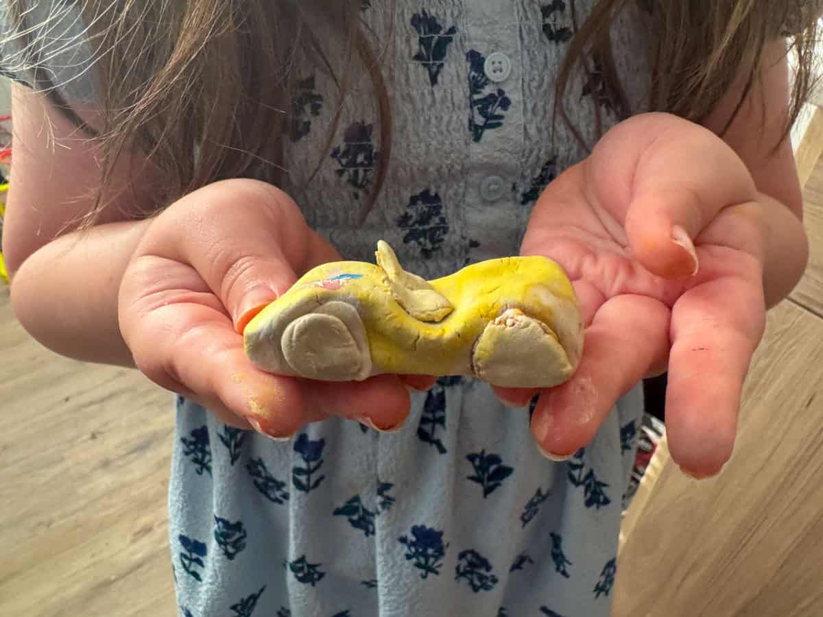 Kat is holding a clay model sports car