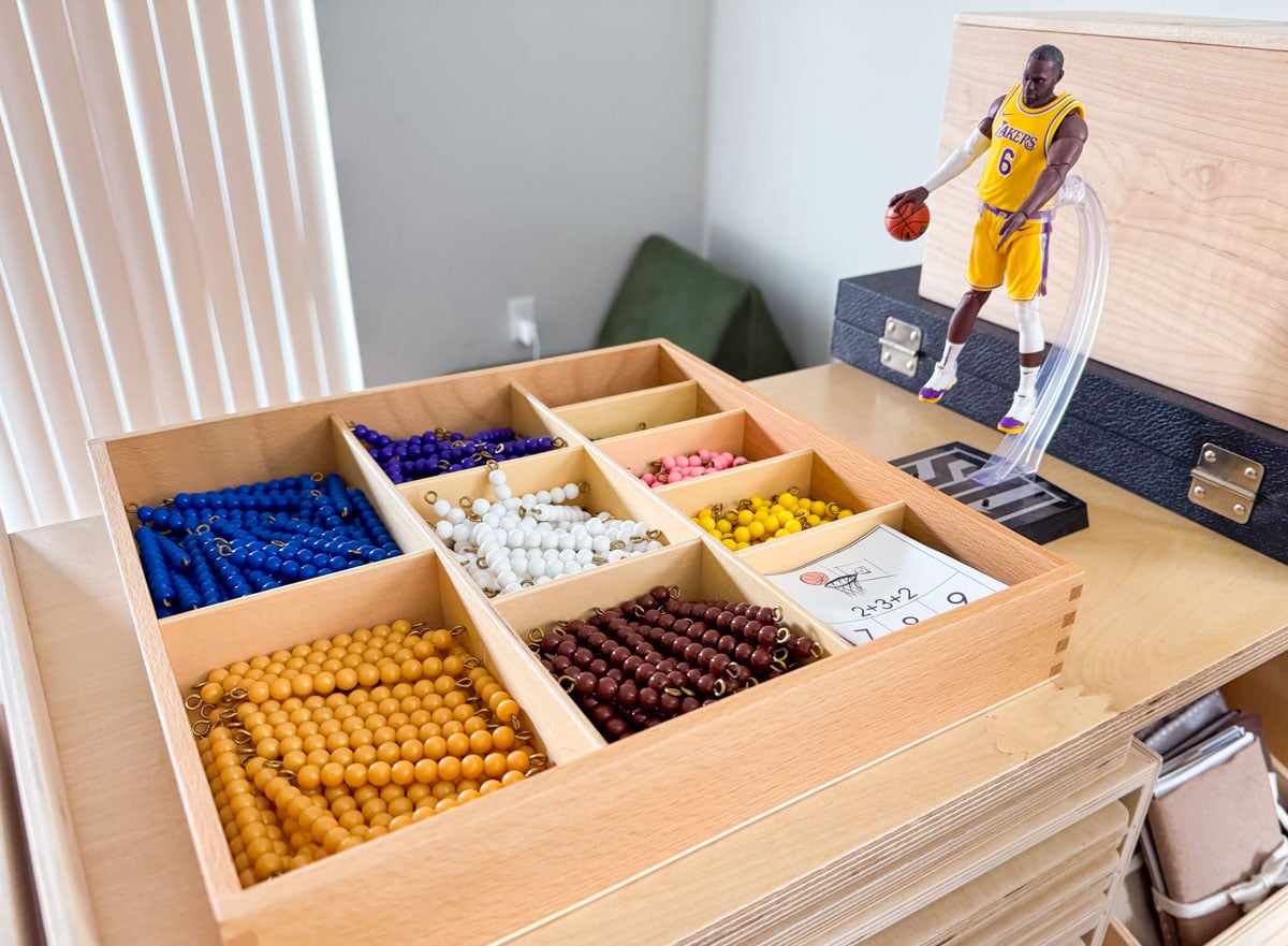 Montessori decanomial bead box on a homeschool shelf