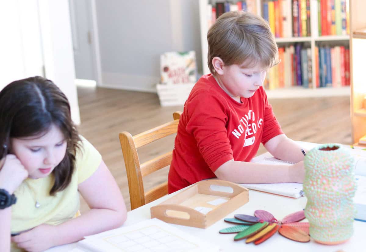 the kids are working on decimal multiplication problems from Montessori Tube Academy