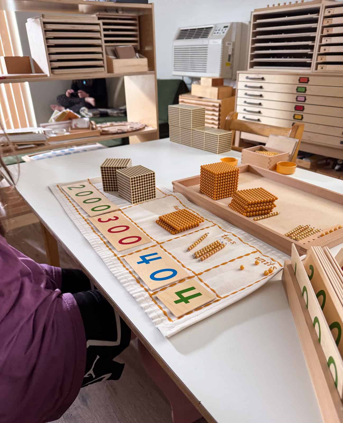 Montessori place value work with golden beads and numeral cards