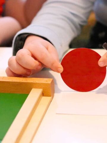 Kaia is tracing the circumference of a circle by rolling it across a lined piece of paper