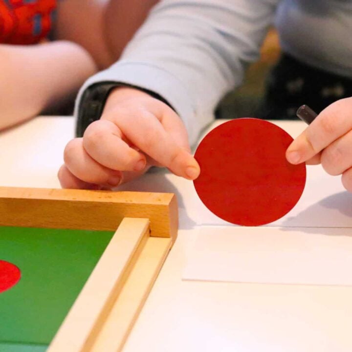 Kaia is tracing the circumference of a circle by rolling it across a lined piece of paper
