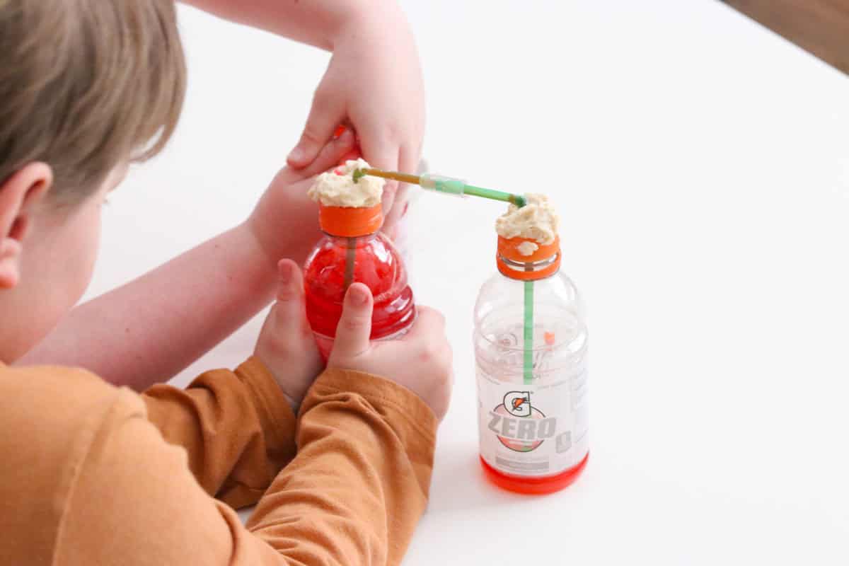 Noah is squeezing the gatorade bottle to simulate the action of the left ventricle