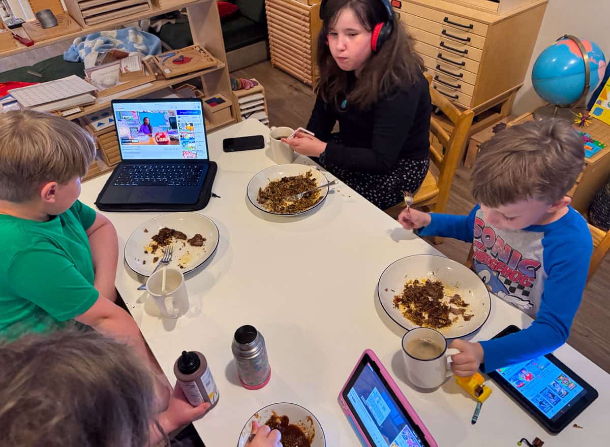 the kids are eating lamb biryani at the table